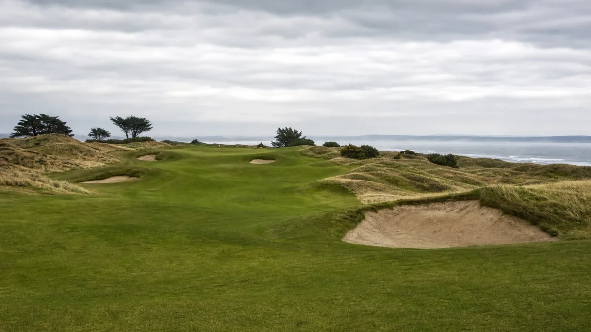 Linksbanas fairway vid havet under en mulen himmel